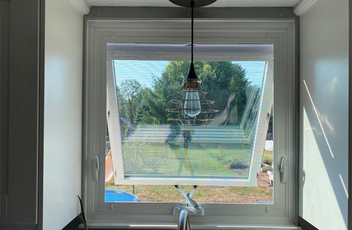An installed awning window on the wall