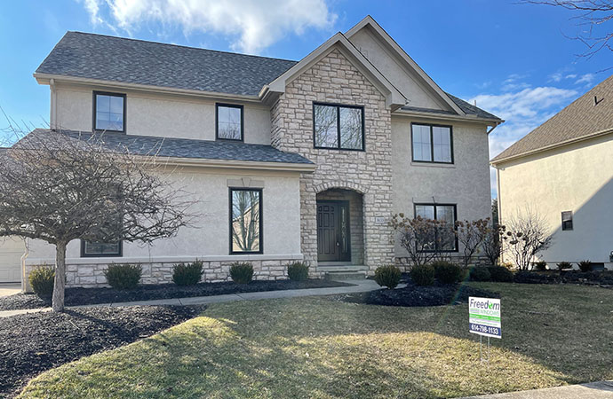 Newly installed casement windows on a residential home with a stone and stucco exterior in Powell, OH